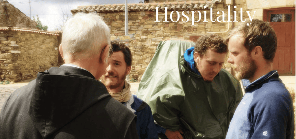 Monk checks in three pilgrims for the night (photo from their website)